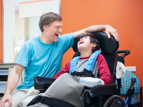 boy in wheelchair with father